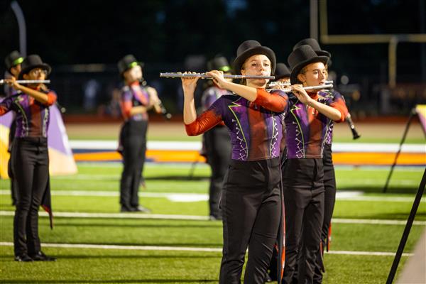 Ravenwood High band members march